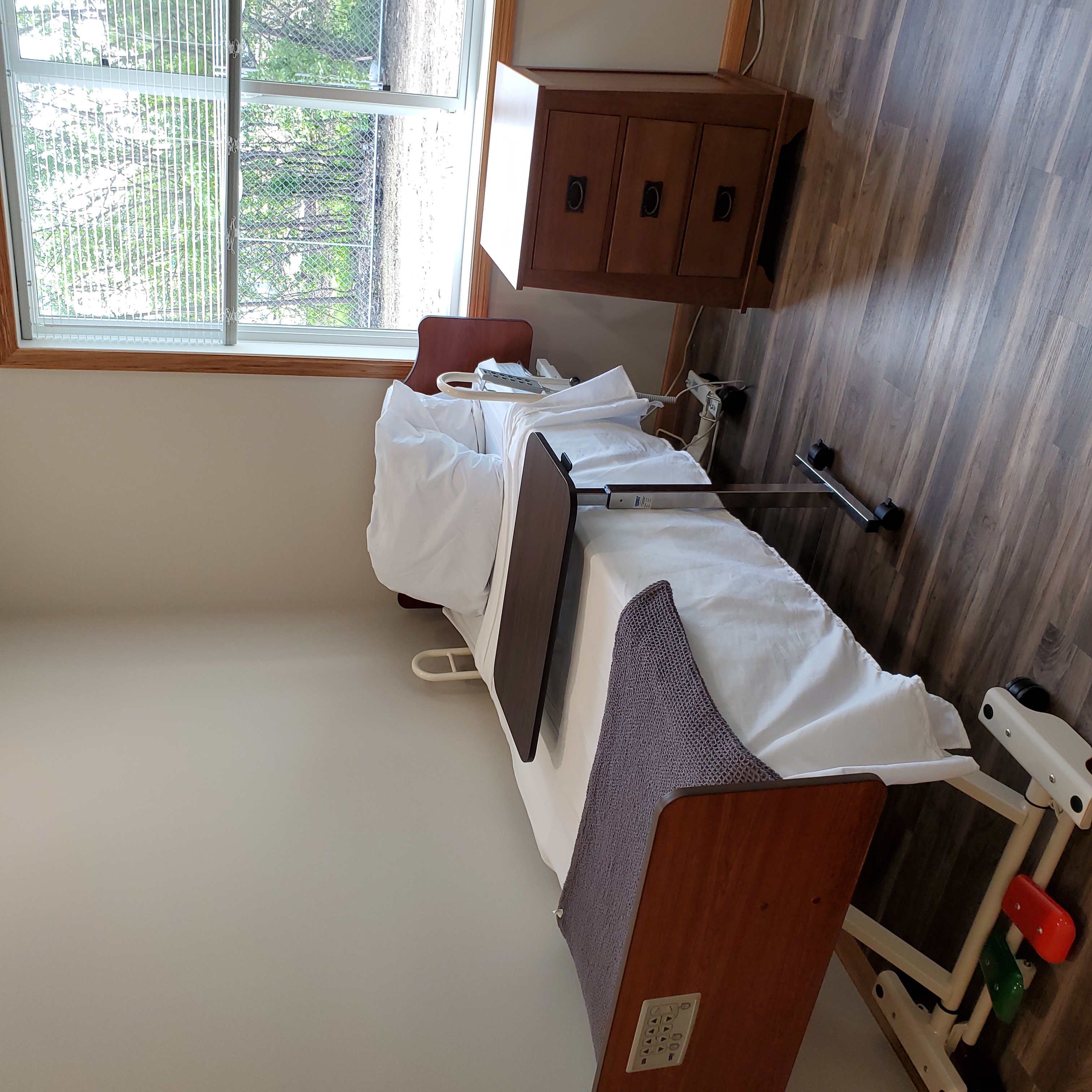 Resident bedroom with window and nightstand
