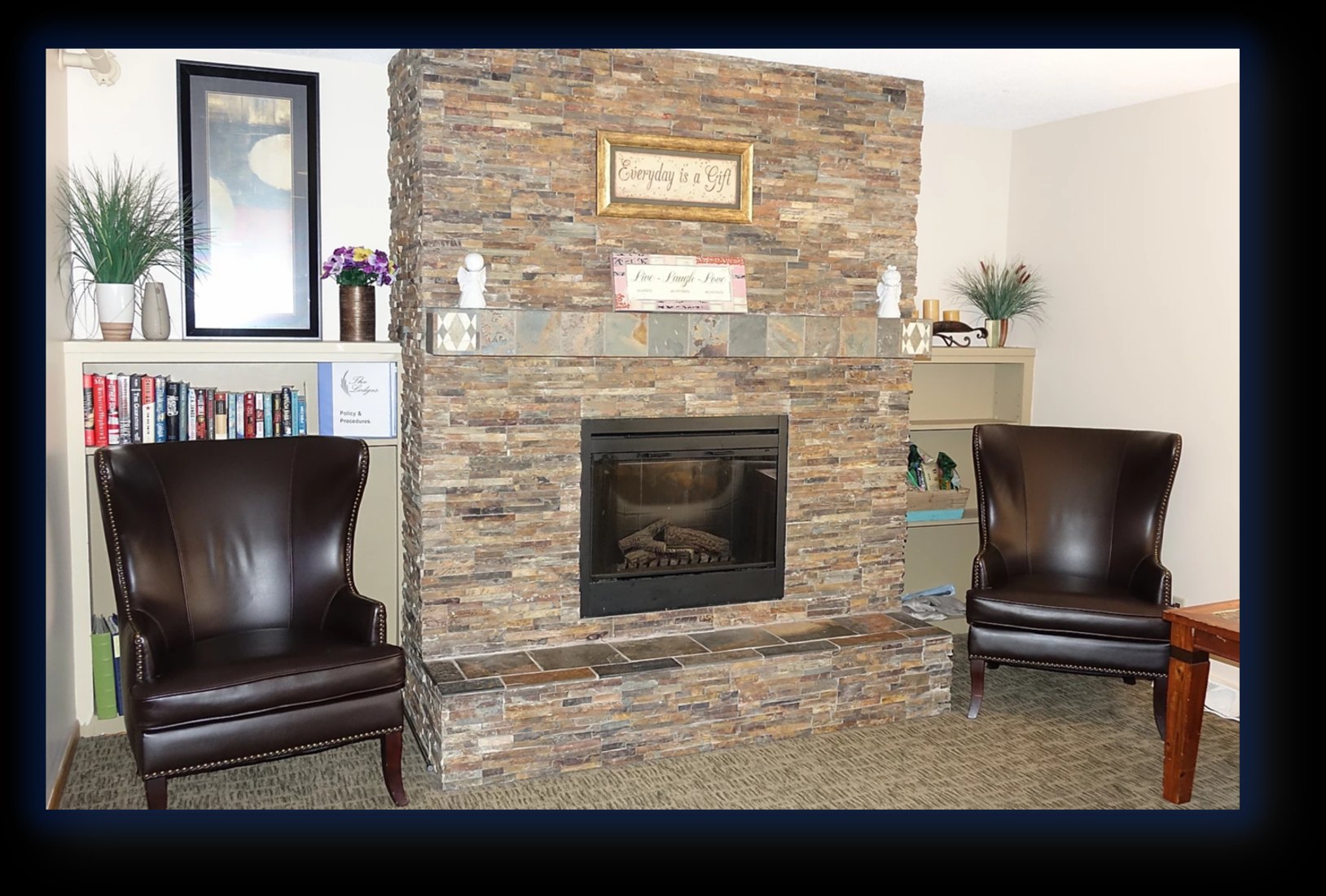 The stone fireplace in the Lodge of Burnsville common room