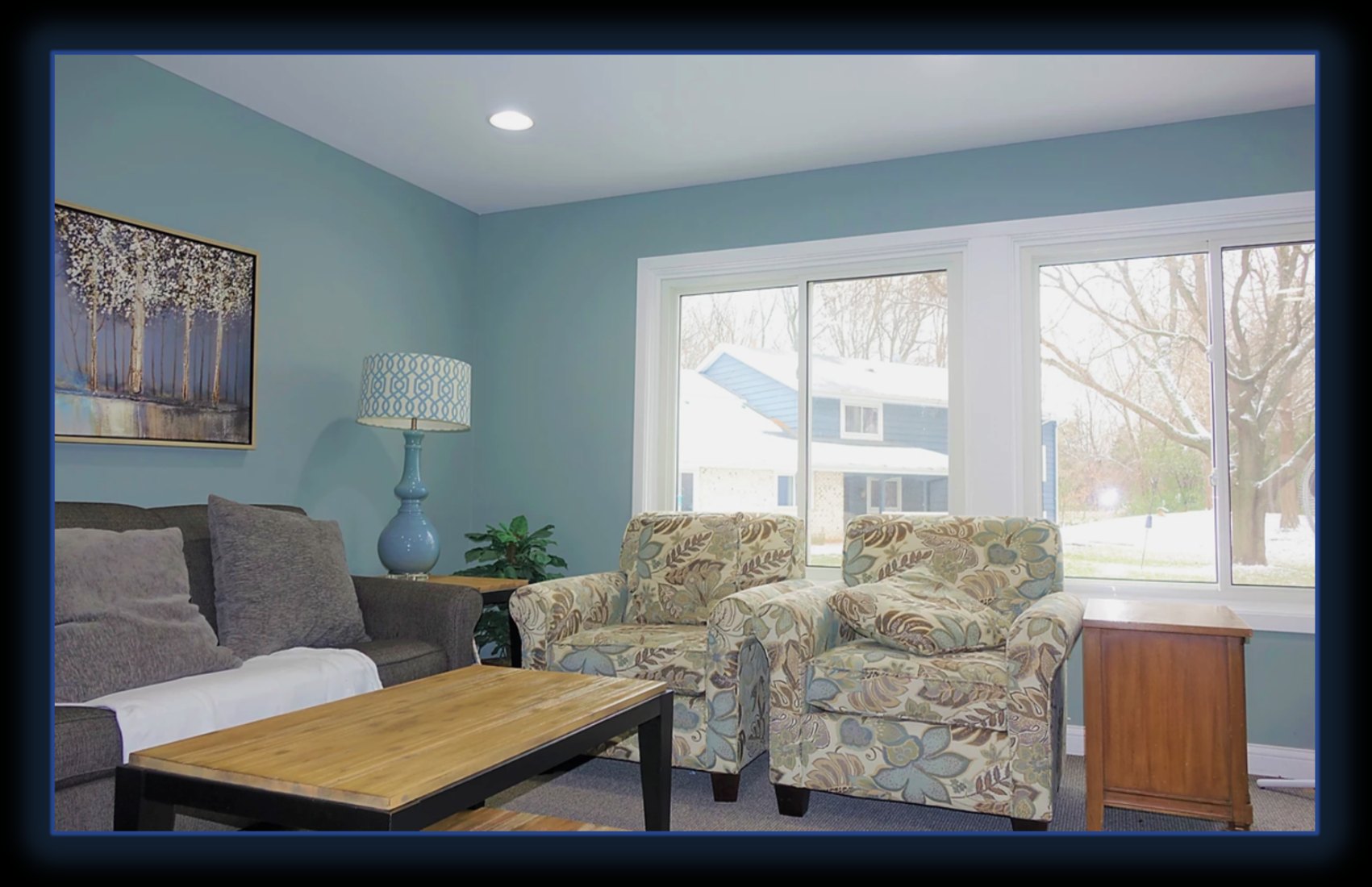 Sunlit common living room with sofa and armchairs